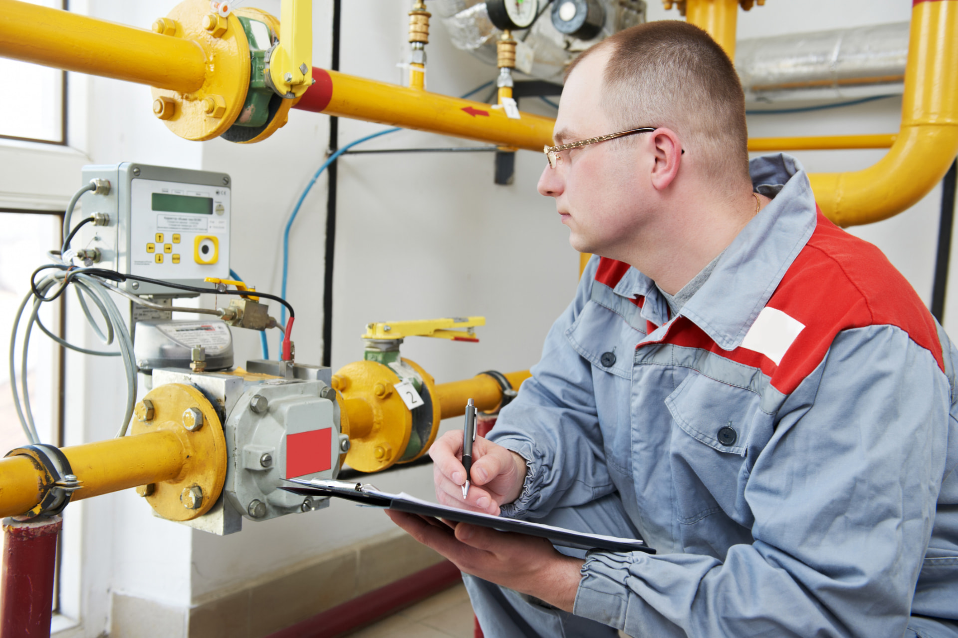 Technician recording diesel fuel sampling readings at a fuel metering station