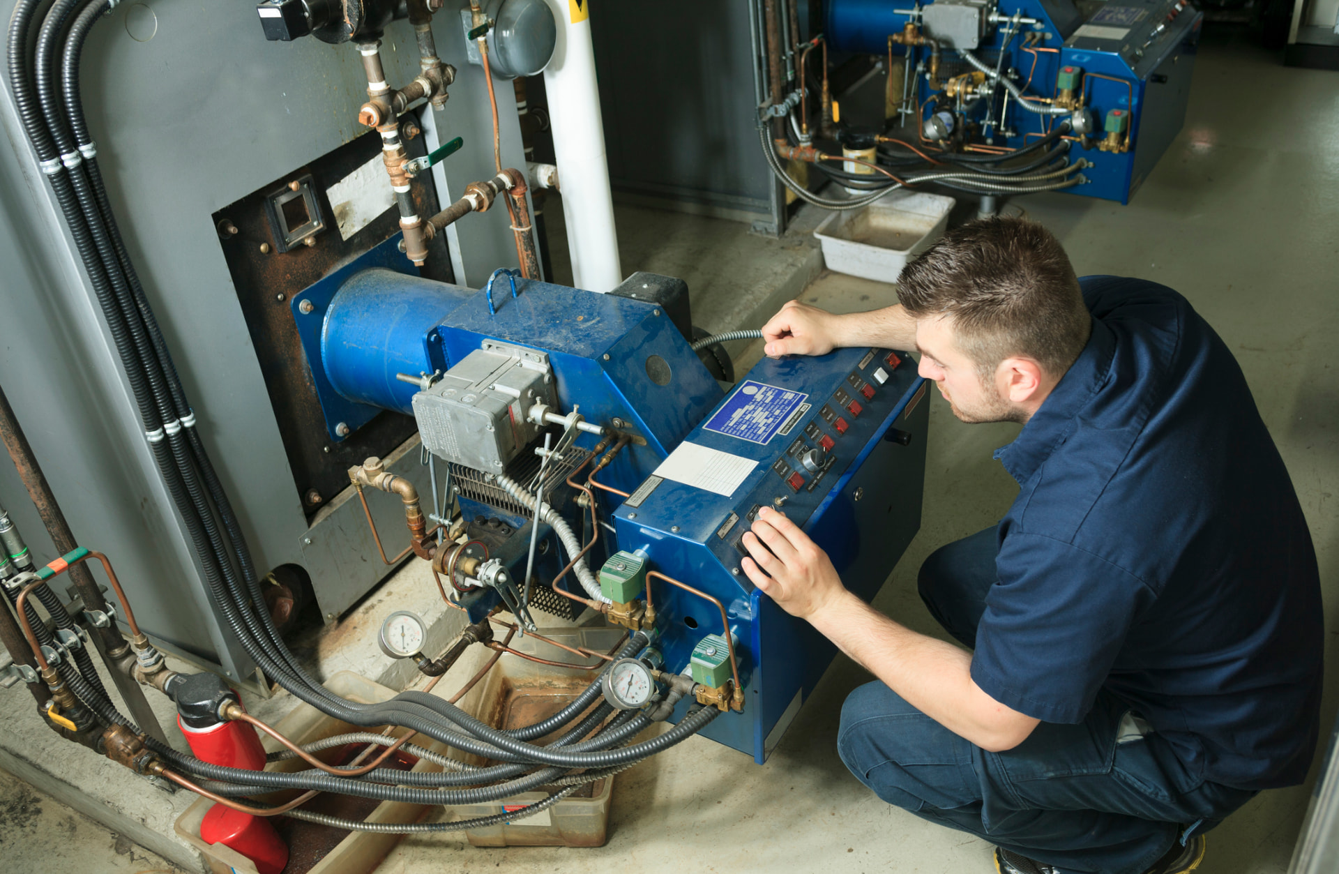 Technician servicing fuel-side equipment during a diesel tank cleaning visit